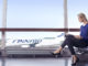 Finnair Airbus A320 with woman at the gate