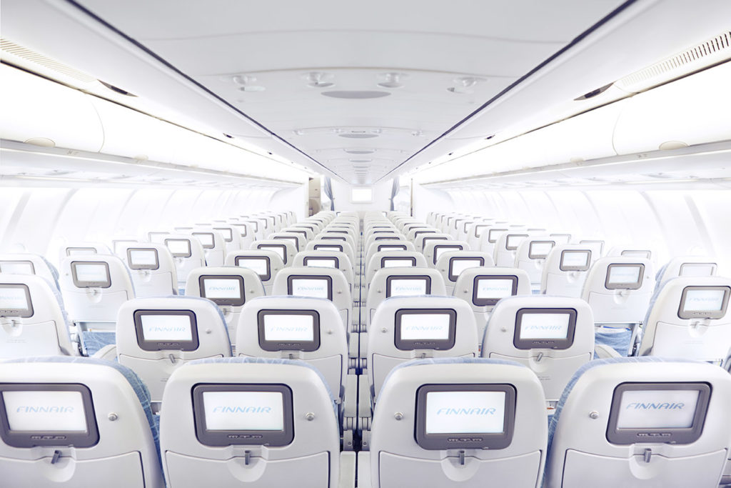 Finnair Airbus A330 economy class cabin from behind with screens