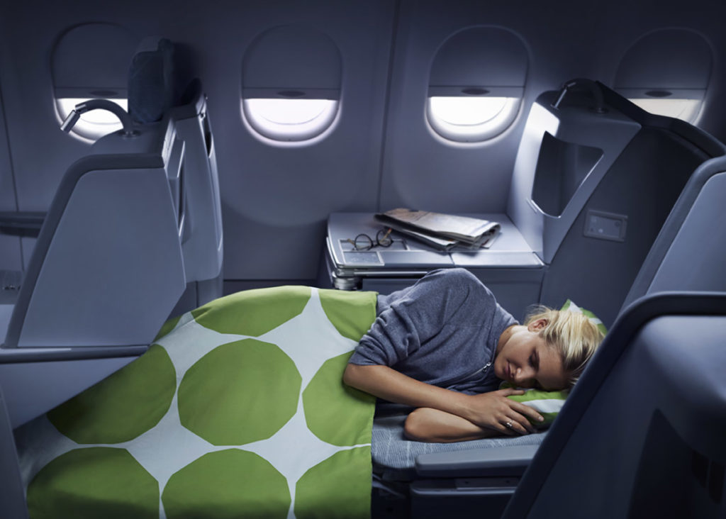Finnair Business Class Airbus A330 woman sleeping with Marimekko blanket