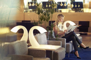 Finnair Business Lounge woman reading a newspaper