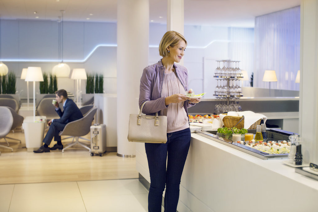 Finnair new Premium Lounge Helsinki Vantaa woman taking food from the buffet