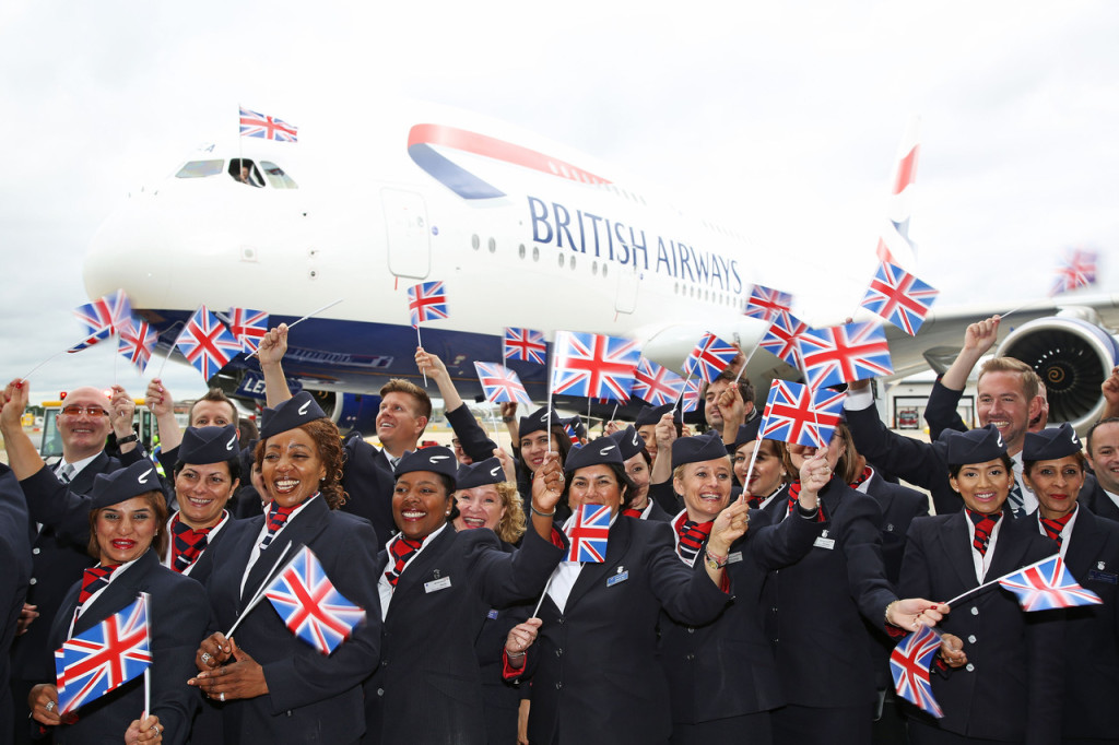 British Airways cabin crew and staff in front of Airbus A380 with British flags