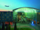 Hilton Munich Airport Hotel exterior with aircraft taking off