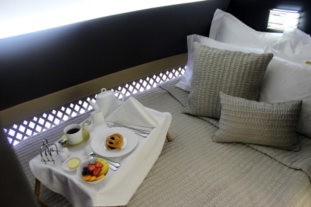 Inside Etihad The Residence bedroom with breakfast tray