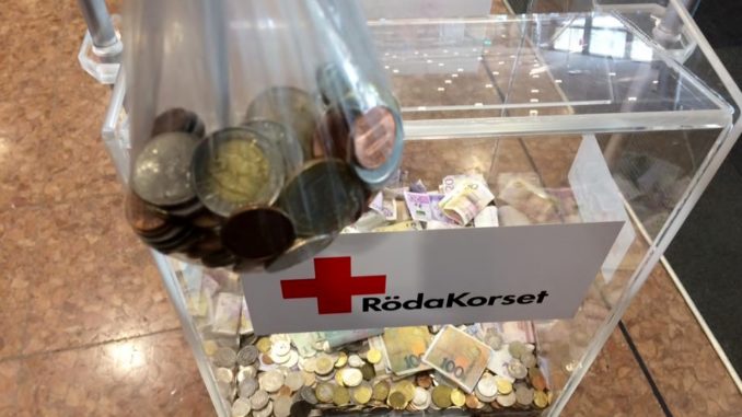 Spare change of different currencies donated to the Red Cross