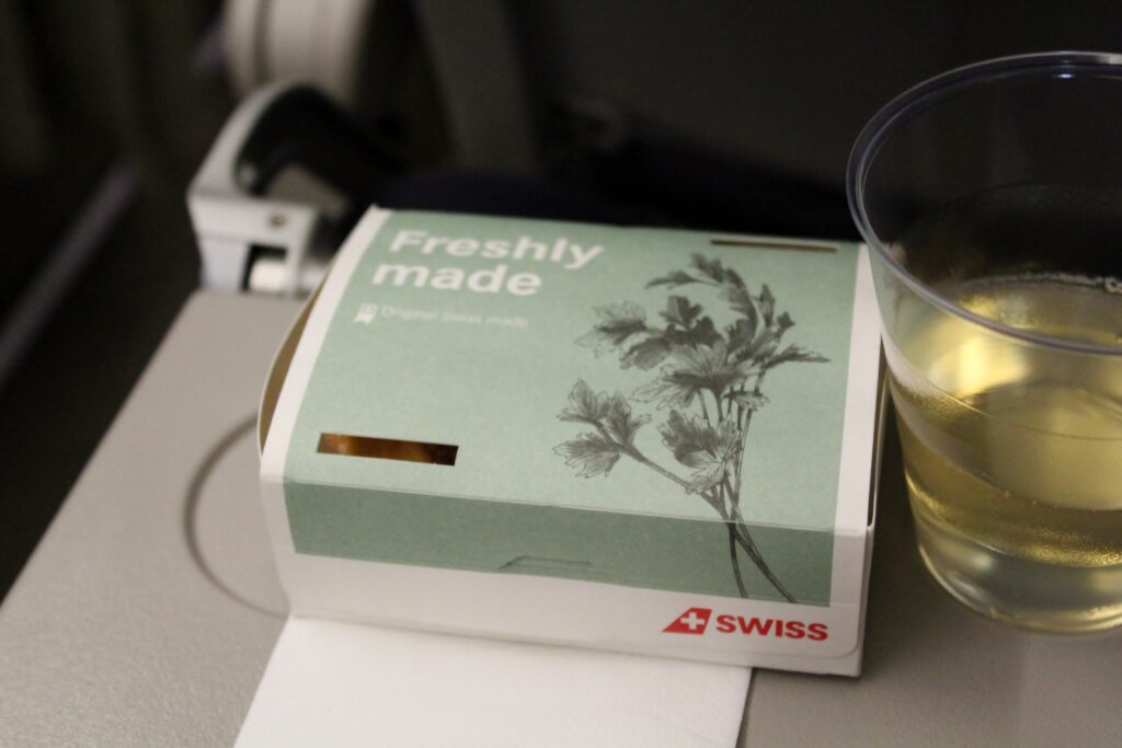 Hot snack and wine in Swiss economy class Stockholm-Zürich